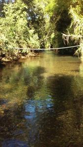 a river with a rope in the middle of it at Chácara Cristo Rei in Senador Canedo +3 photos
