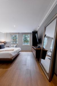 a bedroom with a bed and a large mirror at Capitalia Obelisk Polanco in Mexico City