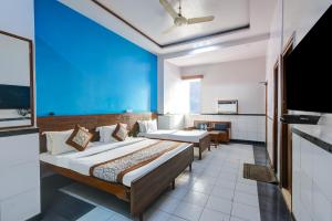a hotel room with two beds and a blue wall at Hotel New Royal Just Near Old Delhi Railway Station And Red Fort in New Delhi +37 photos
