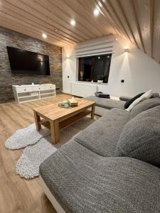 a living room with a couch and a coffee table at Apartmany Zvole in Zvole