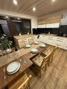 a kitchen with a wooden table with plates on it at Apartmany Zvole in Zvole