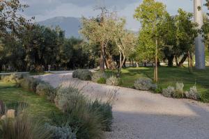a gravel road in a park with trees and grass at Casale Tasciotto in Genazzano