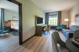 a hotel room with a bed and a mirror at Hotel Rose in Rockford