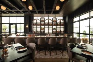 a restaurant with a bar with tables and chairs at Hotel Rose in Rockford +9 photos