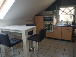 a kitchen with a white table and two chairs at Ferienwohnung Stefanie OG in Bad Breisig