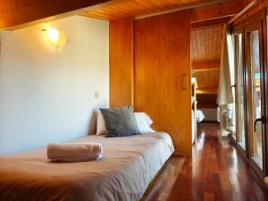 a bedroom with a large bed in a room at Allotjaments Pirineus in Molló +24 photos
