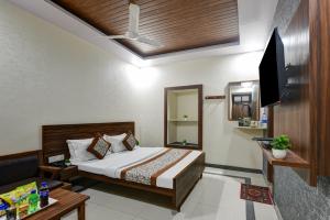 a hotel room with a bed and a television at Hotel New Royal Just Near Old Delhi Railway Station And Red Fort in New Delhi