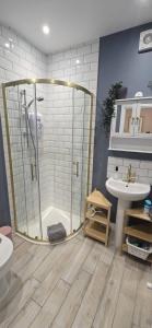 a bathroom with a shower and a sink at Lawson Lodge in Alveston +6 photos