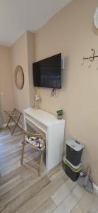 a room with a desk with a television on a wall at Lawson Lodge in Alveston