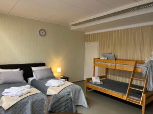a room with two beds and a bunk bed at Hotel Ilomantsi North Star in Ilomantsi +149 photos