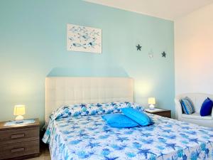 a bedroom with a bed with blue pillows on it at Casa Zoe in Gallipoli +22 photos