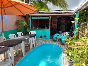 a patio with a table and a swimming pool at Hospedagem Chapéu Virado in Belém