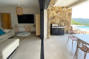 a living room with a couch and a table and a tv at Villa Concarella Di Conca in Conca +7 photos