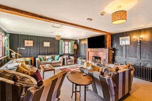 a living room filled with furniture and a fireplace at Huckleberry Farm House in Basildon