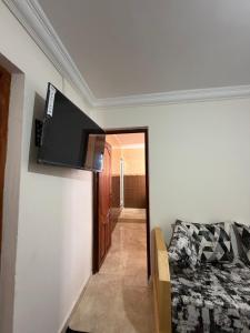 a living room with a flat screen tv on the wall at Samadis Home 2 in Larache +1 photo