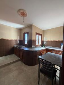 a large kitchen with a table in the middle at Samadis Home 2 in Larache