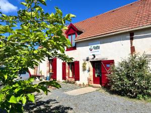 a red and white building with a red door at B&B Les Fruits du Passau in Saint-Désiré