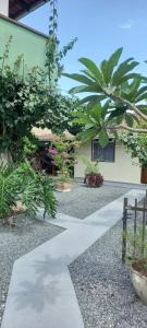 a walkway in front of a building with plants at Espaço da paz in Joinville