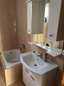 a bathroom with a sink and a bath tub at APARTMAN Iva in Tomislavgrad +7 photos