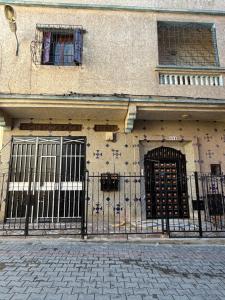 a building with two doors and a fence at Samadis Home 2 in Larache