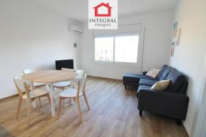 a living room with a table and a couch at Apartament Marea Alta in San Juan de Palamós