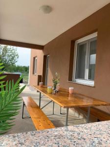 a patio with two wooden tables and a window at Villa Julija with Private Pool in Bilišane