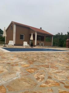 a villa with a swimming pool and a house at Villa Julija with Private Pool in Bilišane