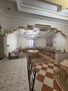 a large room with couches and a checkerboard floor at Samadis Home in Larache