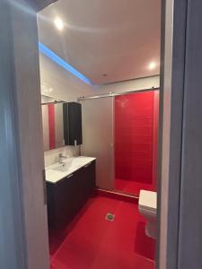 a bathroom with a white sink and a red shower at elva creta beach in Palaiokastro +15 photos