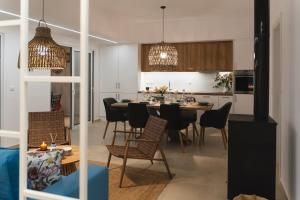 a kitchen and dining room with a table and chairs at Anemone House in Mesokhórion