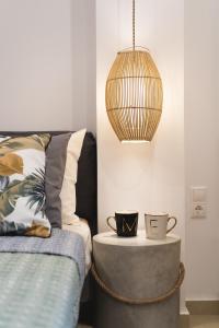 a room with two cups on a table next to a bed at Anemone House in Mesokhórion +6 photos