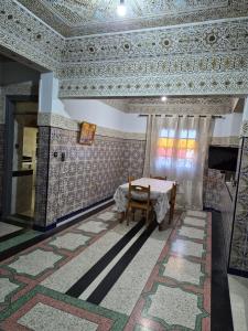a room with a table and a ceiling with tiles at Apparemment familiale villa 110 m2 jardin et piscine in MeknèsKatine