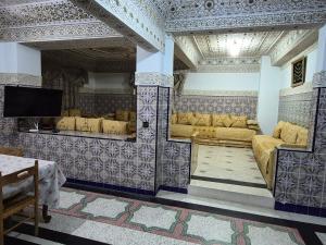 a living room with couches and a flat screen tv at Apparemment familiale villa 110 m2 jardin et piscine in MeknèsKatine