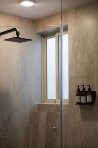 a shower in a bathroom with a glass shower backdoor at Capitalia Obelisk Polanco in Mexico City