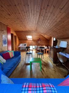 a living room with a blue couch and a table at La Mansarda di Tiziano in Pieve di Cadore