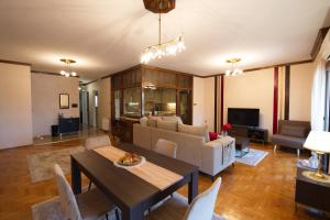 a living room with a table and a couch at Alexandra Welcome Maxi Place in Kastoria