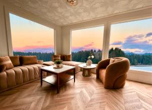 a living room with a couch and a large window at The Florentine Waterfront Hotel in Florence