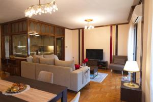 a living room with a couch and a table at Alexandra Welcome Maxi Place in Kastoria