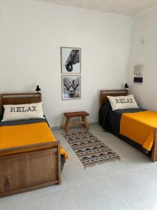 a bedroom with two beds and a table in it at Nuestro Lugar Soñado in Concepción del Uruguay +4 photos