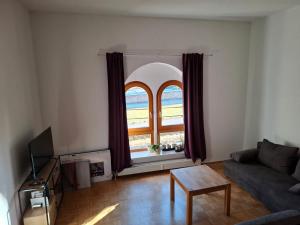 a living room with a couch and a window at Ferienwohnung Alexanderhof in Sankt Lambrecht