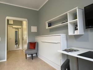 a room with a desk and a chair and a table at Jugendstilhotel Trifels in Annweiler am Trifels