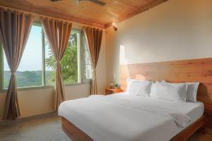 a bedroom with a large bed with a large window at Hotel Sarai Bharatgarh in Nohan +182 photos