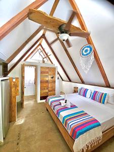 a bedroom with a large bed in a room at Kin Resort Lodge in Maya Beach