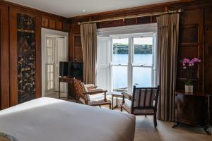 a bedroom with a bed and a large window at The Castle in Castlehaven