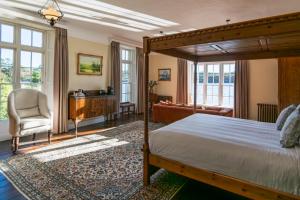a bedroom with a bed and a desk and a chair at The Castle in Castlehaven