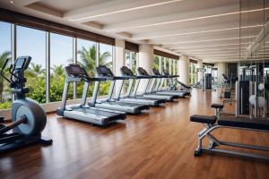 a gym with a row of treadmills and ellipticals at Kappa Senses Zanzibar in Pwani Mchangani