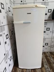 a white refrigerator in a kitchen next to a wall at Beira Mar in Tramandaí