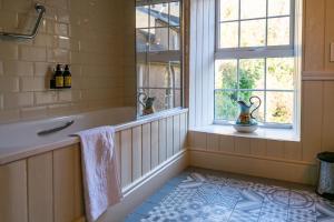 a bathroom with a tub and a window at The Castle in Castlehaven +53 photos