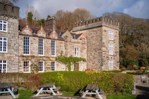 an old castle with picnic tables in front of it at The Castle in Castlehaven