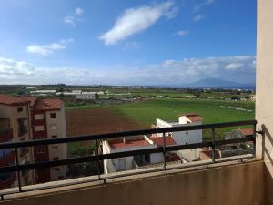 a balcony with a view of a field and buildings at Appartements Mimosa in Tefeschoun